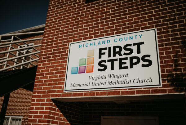 Richland County First Steps board on a bricked wall