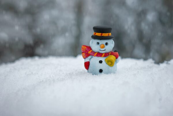 snowman figurine in snow