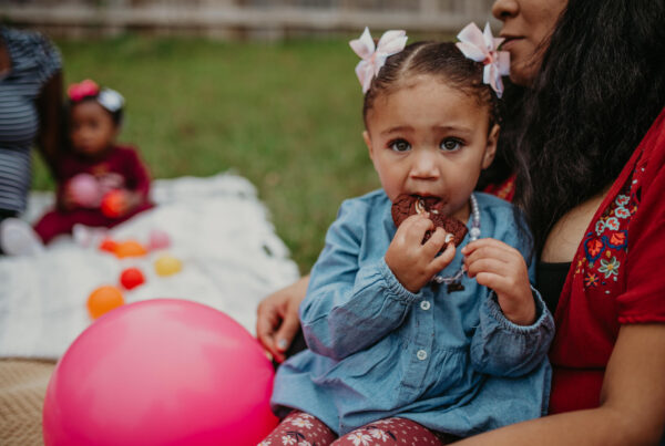 cute little girl eating a cookie
