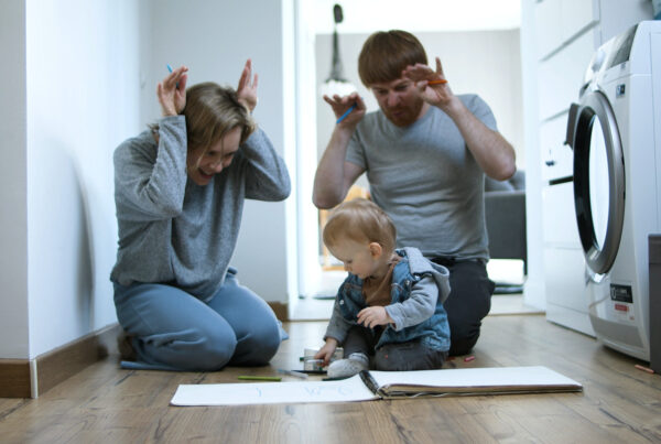 mom and dad playing with small child