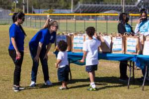 Children pick up resource bags from RFS staff