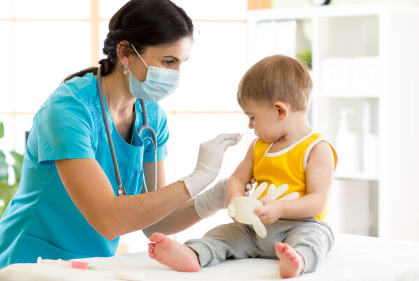 child receiving vaccine from health care provider