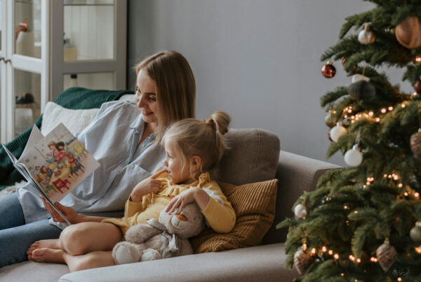 reading story to child chritmas tree